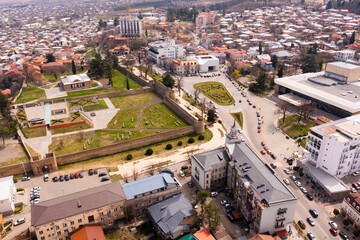 Aerial view of old Georgian town of Telavi overlooking ancient fortified Batonis Tsikhe complex in springtime, Kakheti