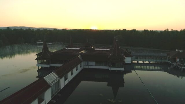 Aerial drone shot of wonderful Lake H&eacute;v&iacute;z at sunrise with sun over the horizon in background