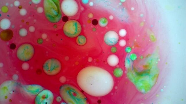 Psychedelic multi-colored bubbles rotate in a liquid light show.