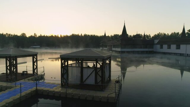 Aerial drone shot of wonderful Lake H&eacute;v&iacute;z at sunrise with sun over the horizon in background