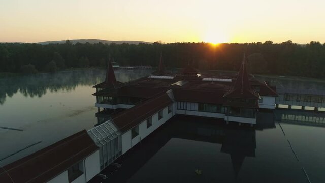 Aerial drone shot of wonderful Lake H&eacute;v&iacute;z at sunrise with sun over the horizon in background