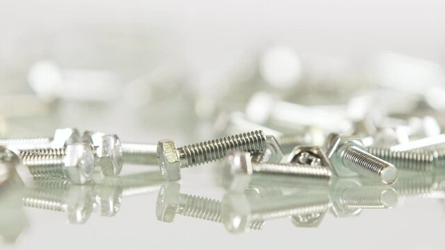Steel screw rotating on white background isolated
