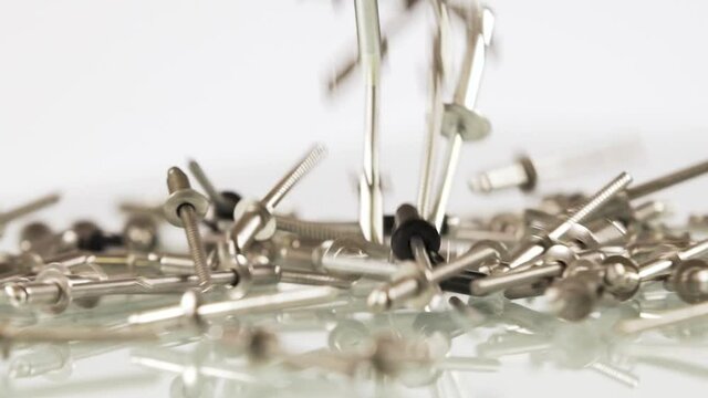 Diferents rivets falling down on white background, isolated
