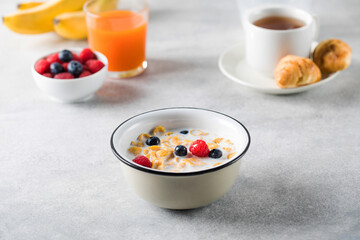 Fototapeta na wymiar Cornflakes with berries and milk. Dry breakfast.