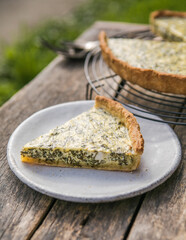 Quiche with spinach - traditional dish of french cuisine. Spinach  tart