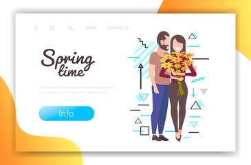 happy young couple with flowers standing together man woman having romantic relationships spring time