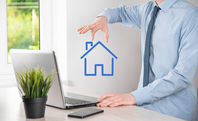 Real estate concept, businessman holding a house icon.House on Hand.Property insurance and security...