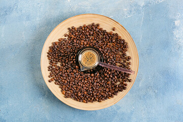 Pot with delicious turkish coffee and plate with beans on color background