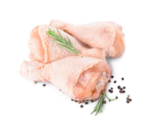 Raw chicken legs and spices on white background
