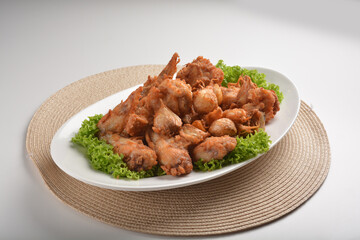 deep fried crispy chicken wing / pork rib with garlic in plate on white table asian cafe restaurant halal menu