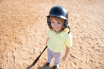 Funny child batter about to hit a pitch during a baseball game. Kid baseball ready to bat. Fun...