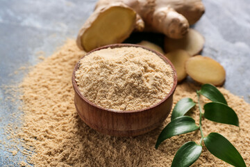 Bowl with ginger powder on color background, closeup