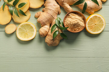 Ginger powder, roots and lemons on color wooden background