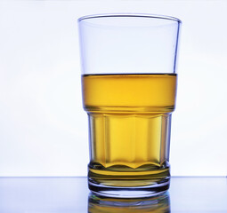 Glass of beer on white back-lit background, lager beer, wet glass, cold alcohol drinks. Closeup cold glass of beer on white background. Refreshment. Cool alcohol drinks. Thick glass, pint of beer