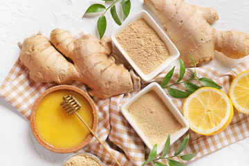 Bowls with ginger powder and honey on white background