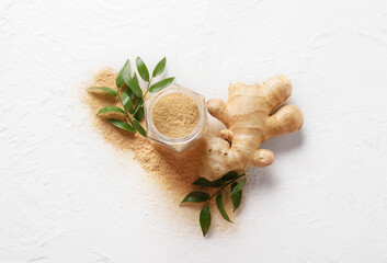 Jar with ground ginger on white background