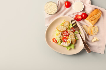 Fototapeta na wymiar Plate of tasty Caesar salad on light background
