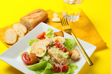 Plate with Caesar salad on color background, closeup
