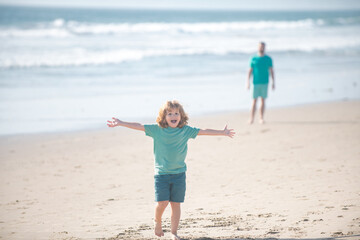 Kid boy walking to beach, raised hands. Amazed surprised kids emotions.