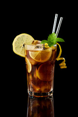 Glass of Fresh Long Island Ice Tea Cocktail - studio shot on black background