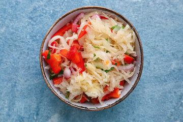 Bowl with tasty sauerkraut on color background