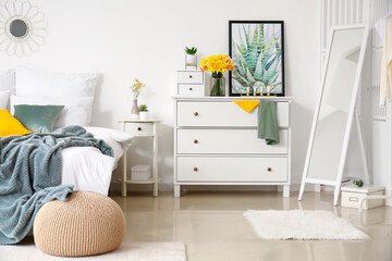 Interior of stylish bedroom with beautiful narcissus flowers