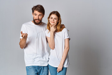 Fototapeta premium young couple in white t-shirts wearing headphones listening to music technology entertainment