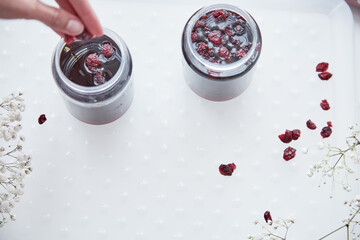 Healthy fermented honey product with cranberry. Food preservative at home, cozy, rustic flat lay. Delicious recipe concept. Anti-viral food. anti-bacterial, anti-viral product. Top view, copy space.