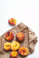 Fresh, ripe peaches on the craft paper package. Summer fruits, in eco-friendly wrapping. Top view, copy space.