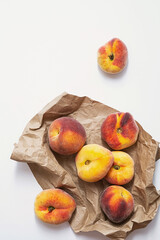 Fresh, ripe peaches on the craft paper package. Summer fruits, in eco-friendly wrapping. Top view, copy space.