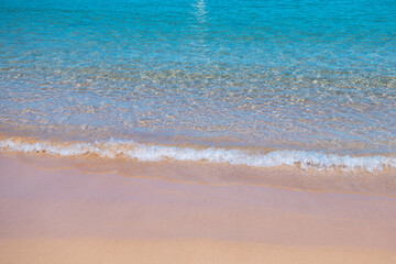 Beach with golden sand, turquoise ocean water. Panoramic sea view. Natural background for summer vacation.