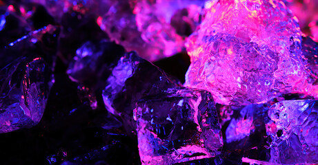 Ice cubes under colored lighting. Background. 