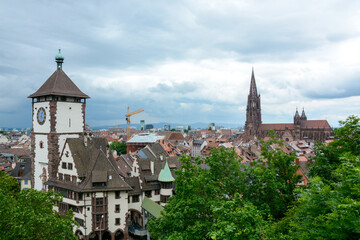 Fototapeta na wymiar Freiburg im Breisgau, June 29, 2021: A storm front forms over the Rhine Valley and the city of Freiburg with a view of the Schwabentor.