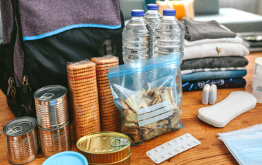 Fototapeta na wymiar Emergency backpack equipment organized on the table in the living room