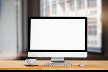 Workspace with computer, keyboard, coffee cup and Mouse with Blank or White Screen Isolated is on the work table at home office.