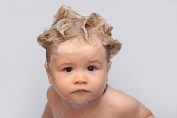 Little baby taking bath, closeup face portrait of smiling boy, health care and kids hygiene. Funny kids face close up.