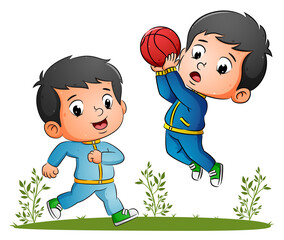 The happy couple boy are playing the basketball together in the garden