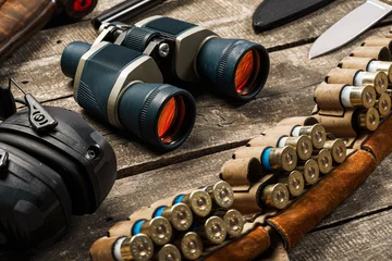Poster Hunting equipment binoculars on wooden background close up © fotofabrika