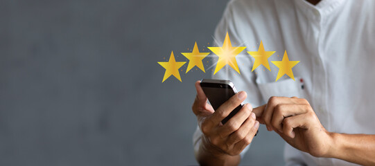 Customer pressing on smartphone with five star icon for feedback review satisfaction service and...
