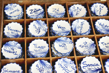 Collection of Portuguese ceramics with names, local handicraft products from Portugal. Exhibition of ceramic tiles in Portugal. Colorful of vintage ceramic dishes in Aveiro, Portugal.