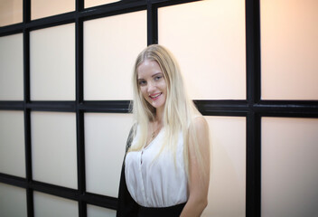 portrait of a beautiful fashion girl with blonde hair posed indoor.