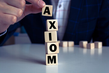 Man made word AXIOM with wood blocks