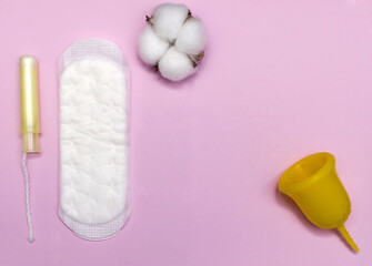 Pink menstrual cup on color background, female intimate hygiene period products,