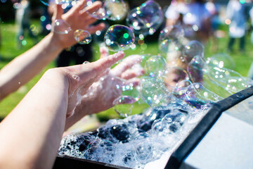 Machine generator for soap bubbles at the children's holiday.