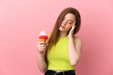 Teenager girl with a cornet ice cream over isolated pink background with headache
