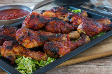 honey glazed and marinated chicken drumsticks on a tray