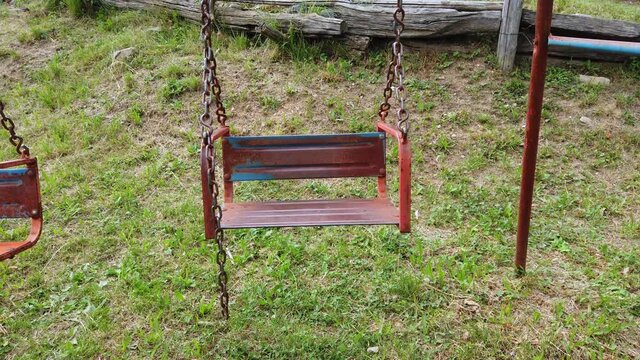 antique vintage iron swing game of red color moves with the wind
