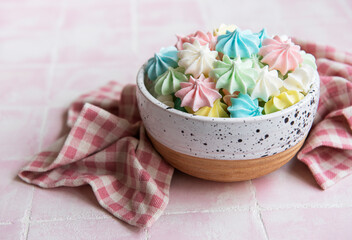 Small colorful meringues in the  ceramic bowl