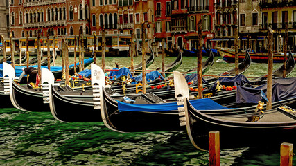 Venetian gondolas, moored on the bank of the Grand Canal.