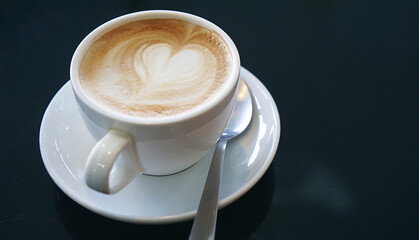 Heart froth of latte hot coffee, Love foam in a white cup, Close up